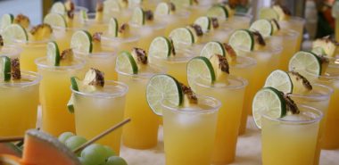 zahlreiche Gläser mit Sommerdrinks und mit Limettenscheiben garniert